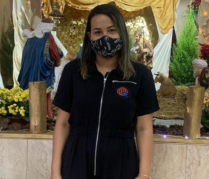 Woman in black outfit and mask stands in front of nativity scene, related to medical students' apology for mocking transplants. Woman in black outfit and mask stands in front of nativity scene, related to medical students' apology for mocking transplants.