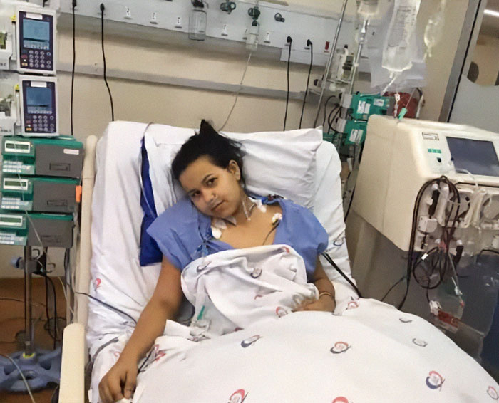 Patient in hospital bed after multiple transplants, surrounded by medical equipment. Patient in hospital bed after multiple transplants, surrounded by medical equipment.