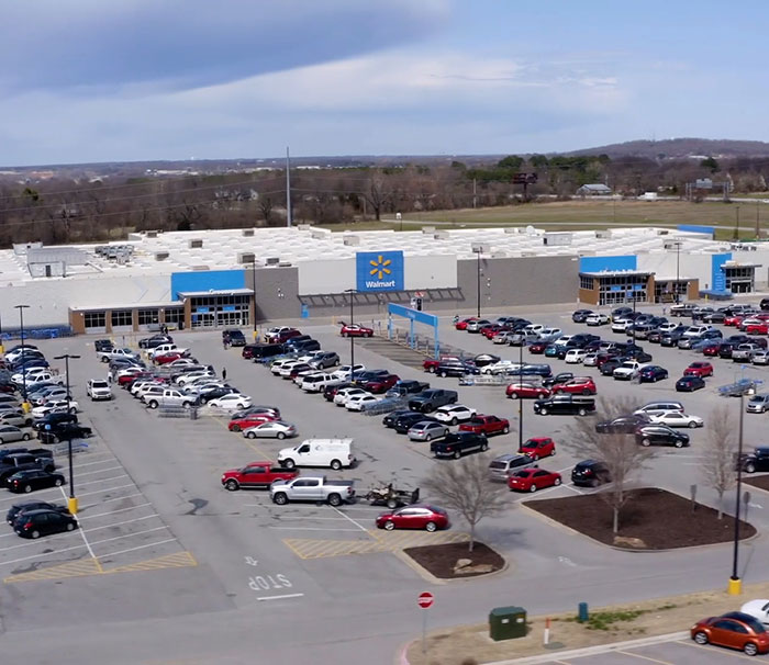 Walmart parking lot filled with cars, showcasing a busy retail environment on a clear day. Walmart parking lot filled with cars, showcasing a busy retail environment on a clear day.