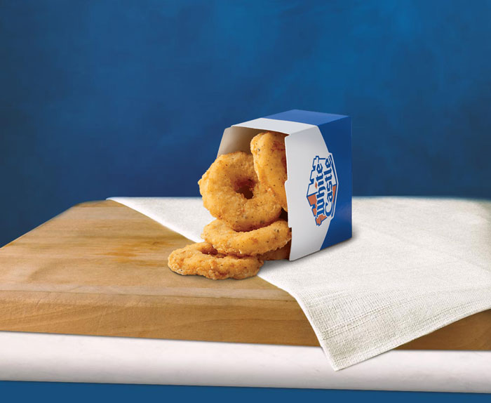 White Castle chicken rings in blue box on napkin, showcasing their $3.99 deal.