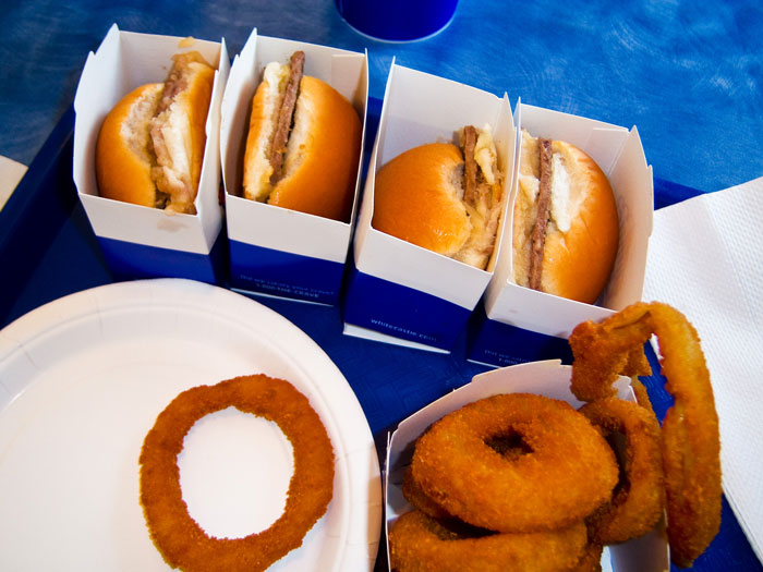 White Castle sliders and chicken rings on a blue tray, showcasing their $3.99 Chicken Rings deal. White Castle sliders and chicken rings on a blue tray, showcasing their $3.99 Chicken Rings deal.