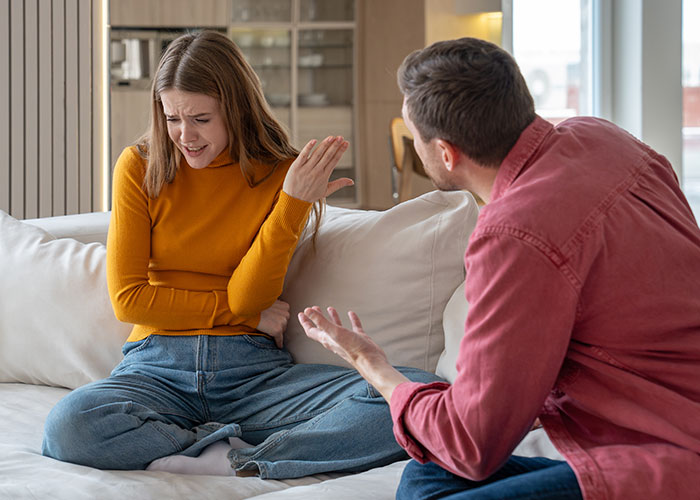 Woman arguing with boyfriend on a couch about rent money. Woman arguing with boyfriend on a couch about rent money.