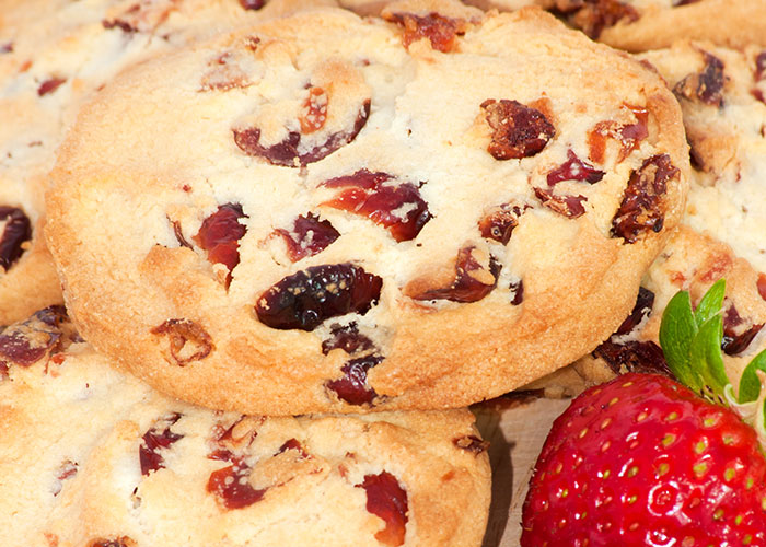 Close-up of cranberry cookies with fresh strawberry, related to refusing to pay medical bills after allergic reaction.