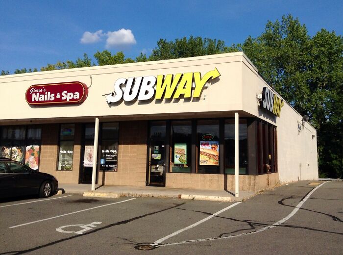Subway restaurant storefront next to a nail spa, illustrating industry secrets behind closed doors in business.