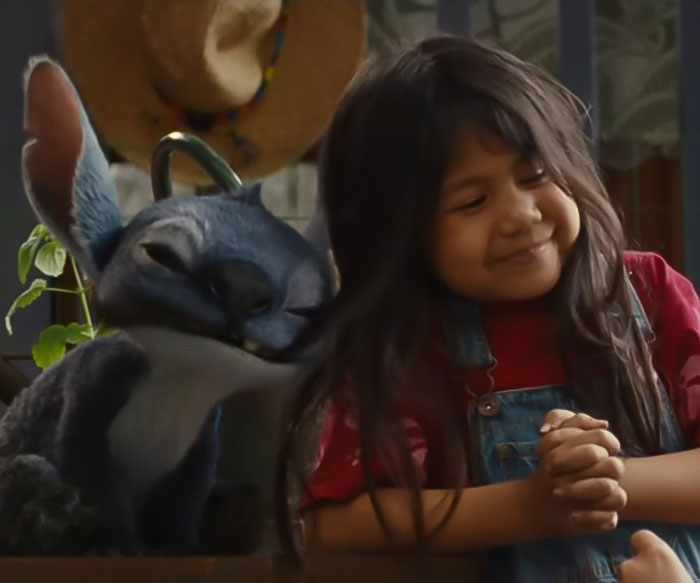 Young girl smiling next to a redesigned Stitch character in Lilo & Stitch's live-action, sparking Disney fans outrage. Young girl smiling next to a redesigned Stitch character in Lilo & Stitch's live-action, sparking Disney fans outrage.