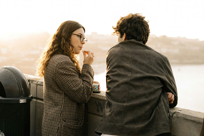Couple having a private conversation outdoors at sunset, symbolizing secrets spouses keep after marriage.