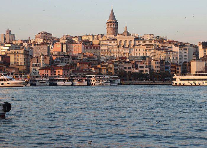 Waterfront cityscape with boats and historic buildings showcasing the best and worst things about living in countries