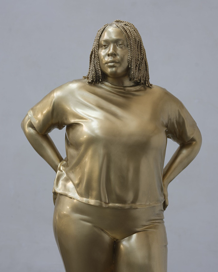 Bronze statue of Black woman with braided hair in casual clothing, representing debate over public art in NYC Times Square. Bronze statue of Black woman with braided hair in casual clothing, representing debate over public art in NYC Times Square.