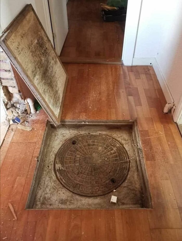 Hidden manhole cover found inside a home with a forgotten past, revealing strange and unusual items beneath the floor. Hidden manhole cover found inside a home with a forgotten past, revealing strange and unusual items beneath the floor.