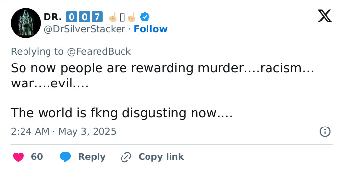 Tweet by Dr. 007 commenting on society rewarding racism and expressing disgust with the current state of the world. Tweet by Dr. 007 commenting on society rewarding racism and expressing disgust with the current state of the world.