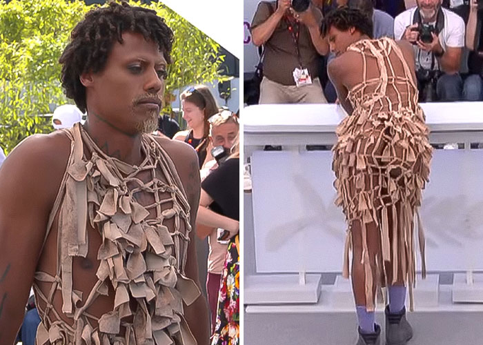 Star at Cannes revealing backside in a unique dress, breaking dress code to applause from photographers and crowd. Star at Cannes revealing backside in a unique dress, breaking dress code to applause from photographers and crowd.