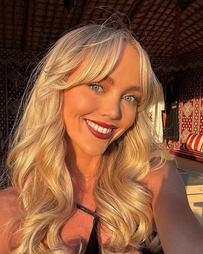 Adult content creator smiling with long blonde hair, sharing hospital update after bleeding incident outdoors in warm light. Adult content creator smiling with long blonde hair, sharing hospital update after bleeding incident outdoors in warm light.
