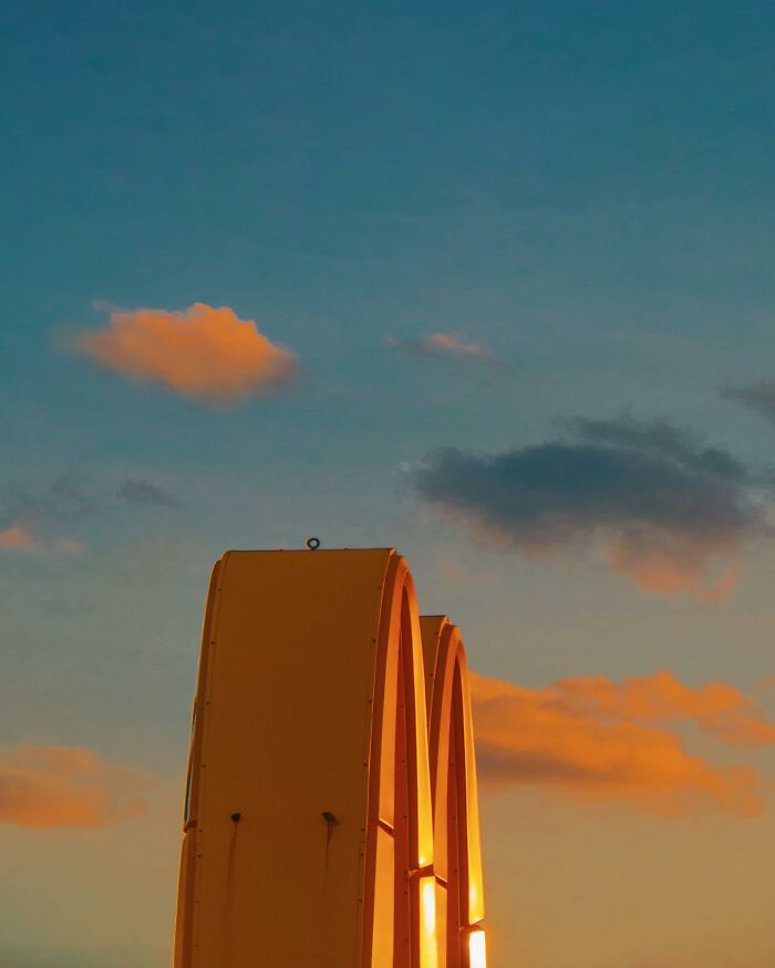 Golden arches under a vibrant sky, showcasing creative photo manipulations that invite us to a surreal reality.