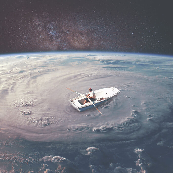 Man in a small boat rowing at the center of a swirling cloud formation in a surreal photo manipulation collage.