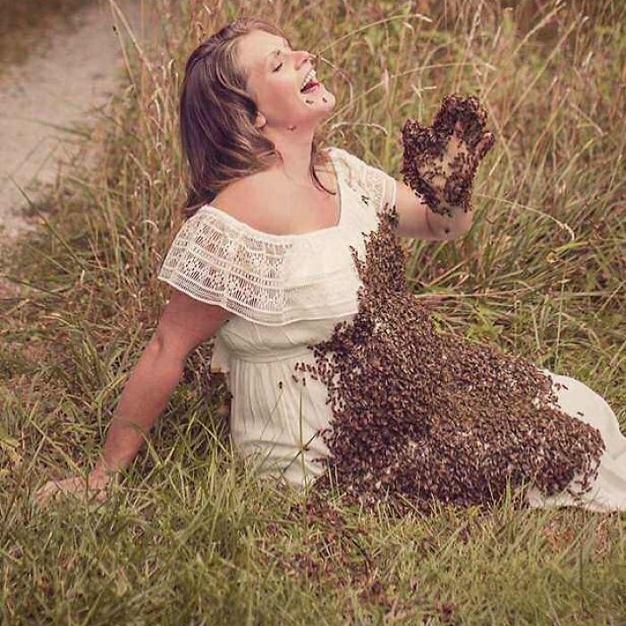 A woman sitting in grass covered in bees, illustrating a cursed image for when your brain needs a weird break.