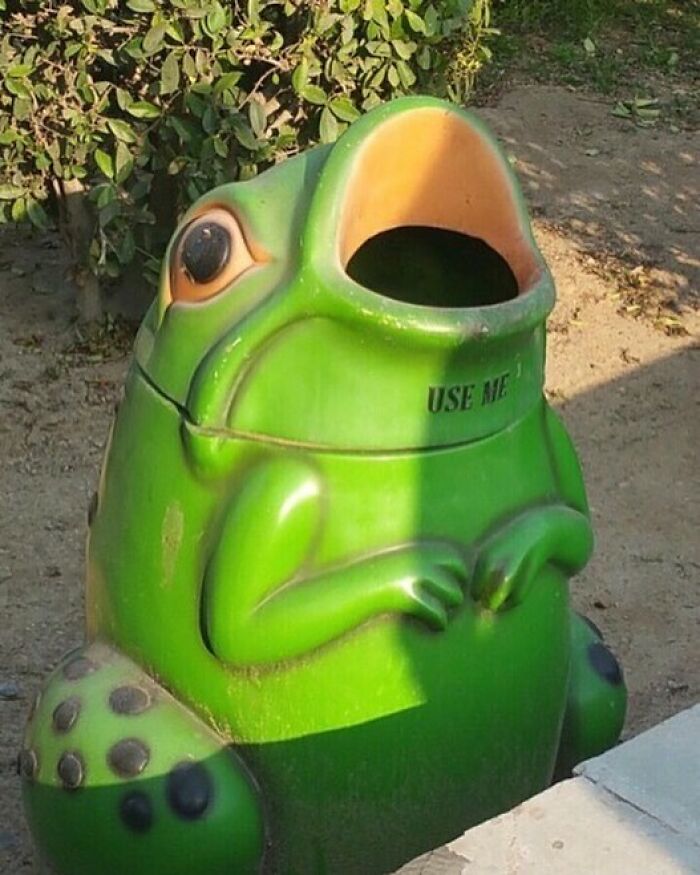 Green frog-shaped trash can with large open mouth and "use me" text, a cursed image that gives a weird visual break.