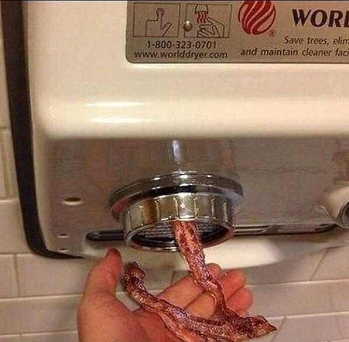 Hand dryer blowing out cooked bacon strips instead of warm air, a cursed image for when your brain needs a weird break.