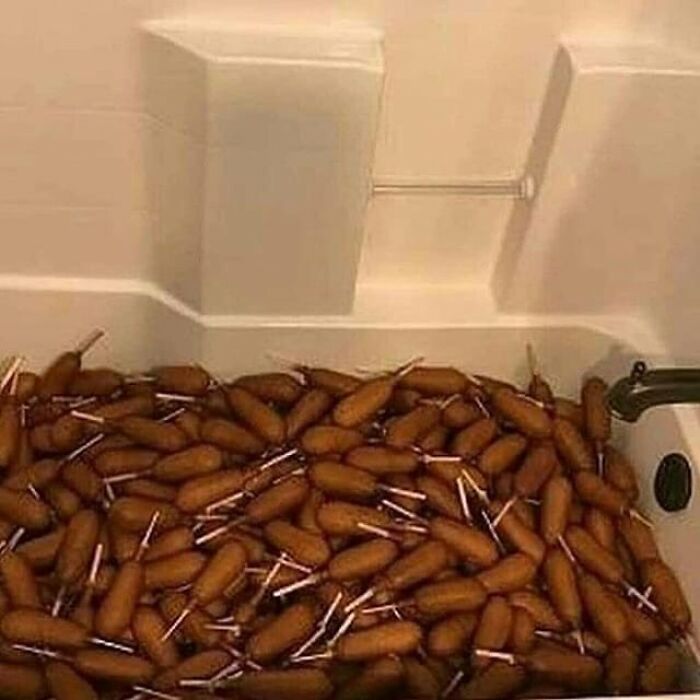 Bathtub filled with numerous corndogs, creating a bizarre and cursed image for a weird visual break.