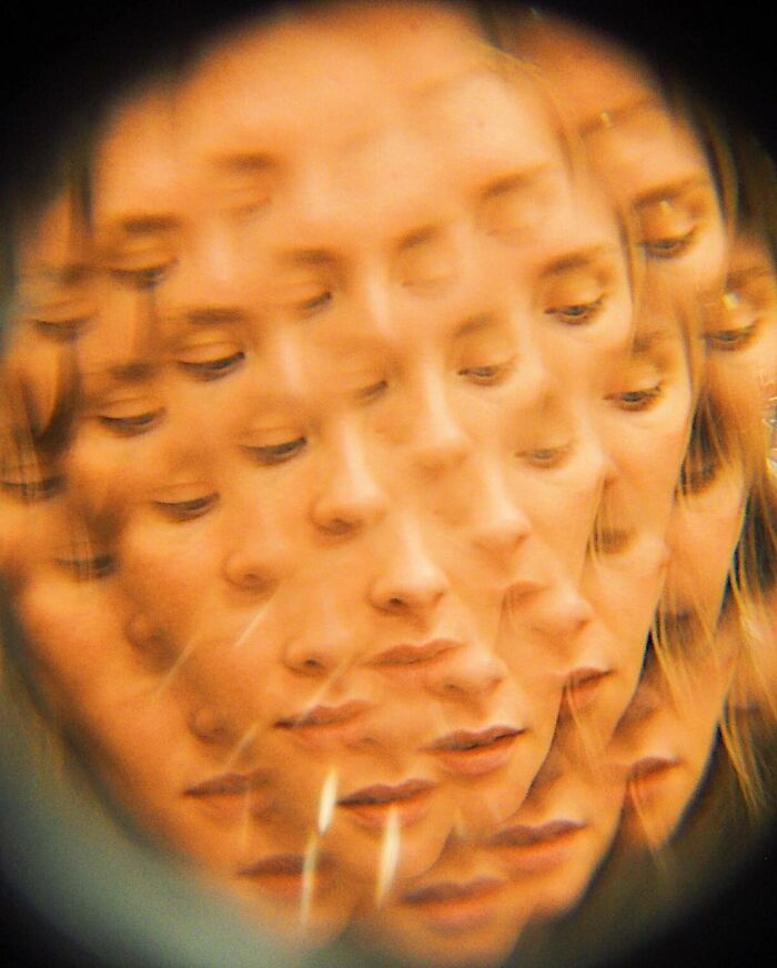 Multiple overlapping faces of a woman with eyes closed created using creative photo manipulation techniques.