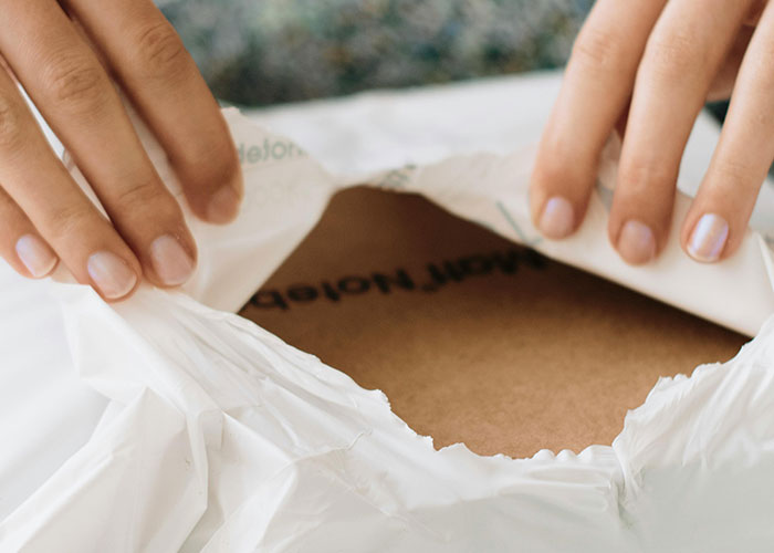 Hands opening a package, illustrating a woman dealing with a neighbor stealing packages in a petty response. Hands opening a package, illustrating a woman dealing with a neighbor stealing packages in a petty response.