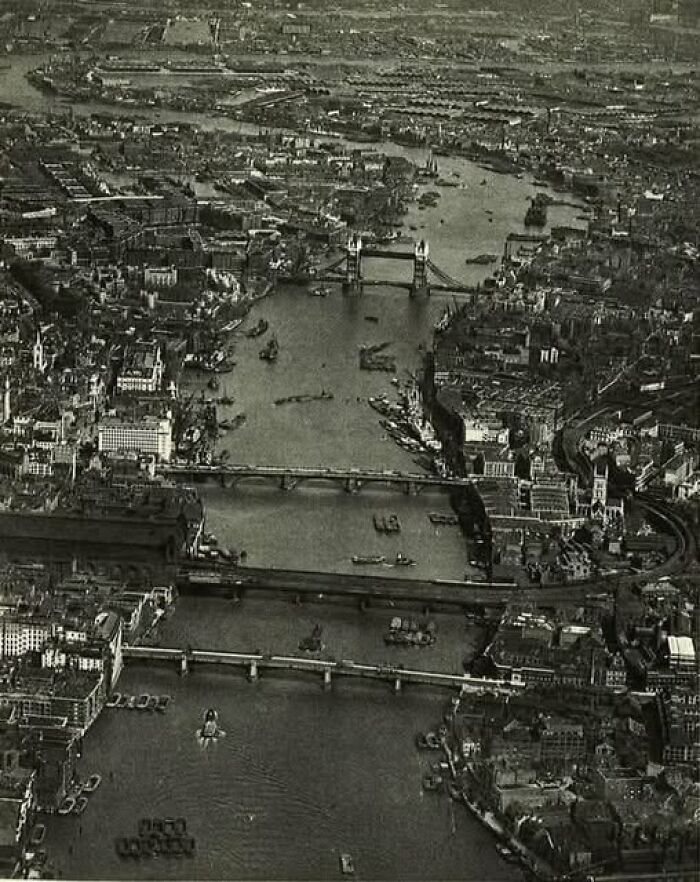 Aerial view of London with bridges over the River Thames in an antique historical photograph from the past.