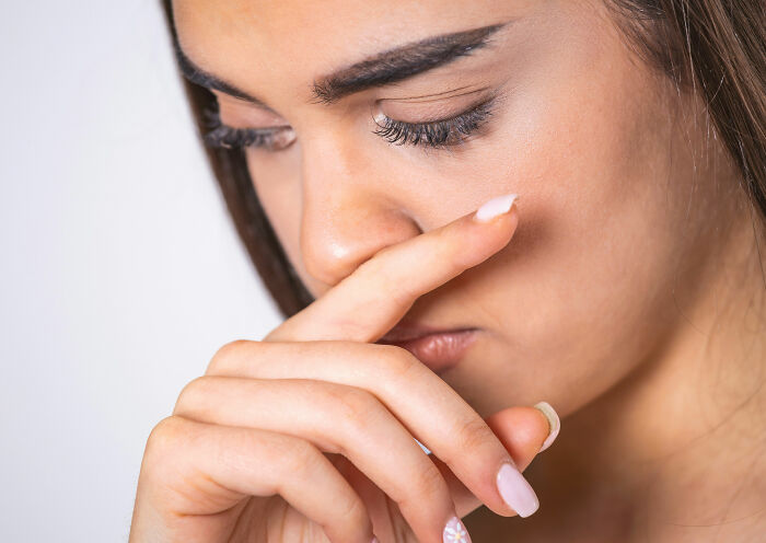 Close-up of a woman showing emotion, reflecting on secrets spouses keep after marriage and personal feelings.