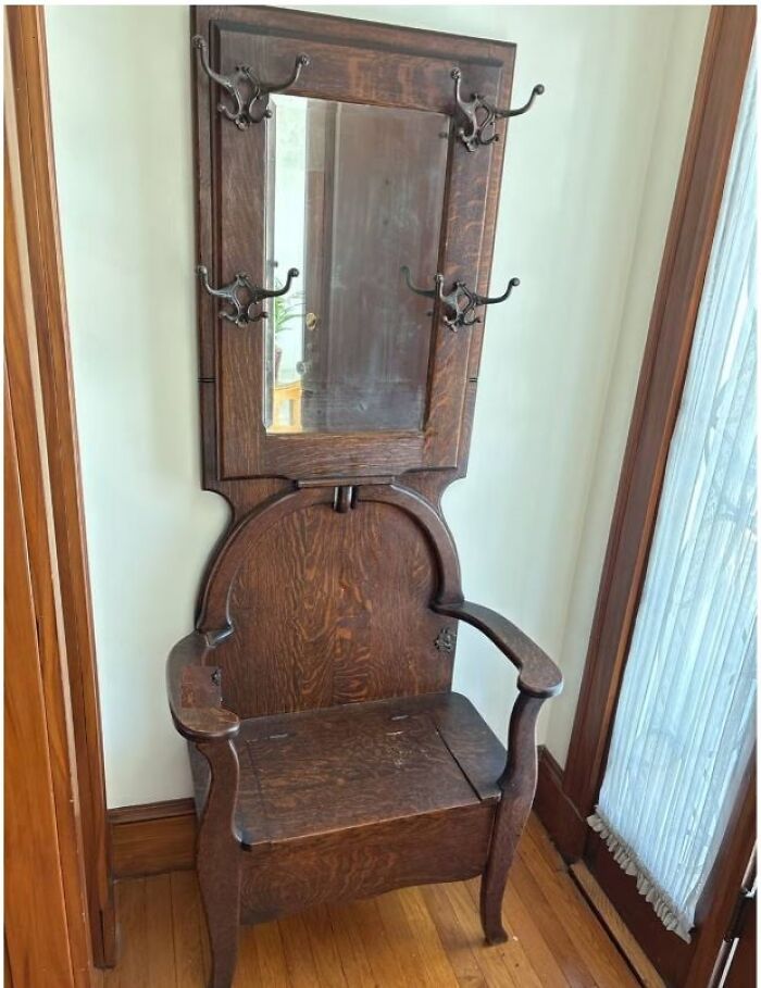 Antique wooden hall tree with mirror and hooks, a strange thing found in homes with hidden or haunted pasts. Antique wooden hall tree with mirror and hooks, a strange thing found in homes with hidden or haunted pasts.