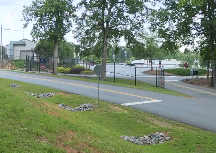 Entrance road to a Christian school campus surrounded by trees and fencing amid debate over teen girl expelled for trans prom date. Entrance road to a Christian school campus surrounded by trees and fencing amid debate over teen girl expelled for trans prom date.