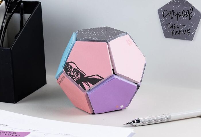 Colorful hexagonal desktop organizer among office supplies, an example of office supplies to enhance your desk.