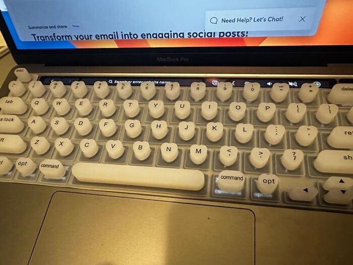 Laptop keyboard with white retro-style keycaps, an office supply that might make you look forward to your desk.