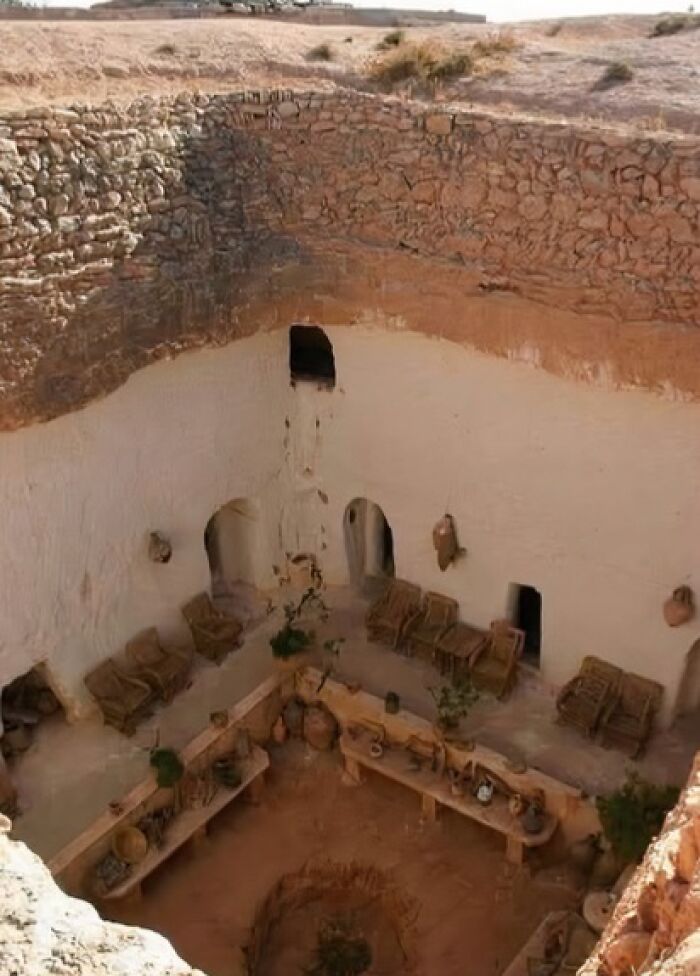 Ancient underground room with pottery and woven chairs, featured in archaeology news and architecture discoveries.