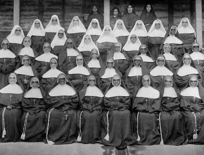 Group portrait of African American nuns dressed in religious habits, representing African American life in 1900.