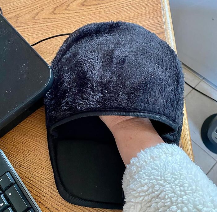 Cozy desk hand warmer on a wooden desk, perfect for creating a Monday happy place at your workspace.