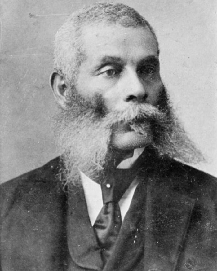 Portrait of an African American man with a large beard, representing African American life from the 1900 Paris Exposition.