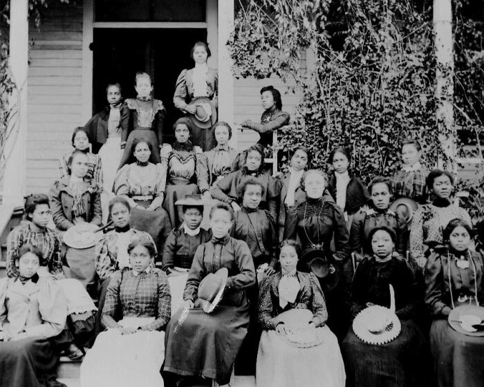 Group of African American women posing on a porch, showcasing life and fashion in early 1900s historical photos.
