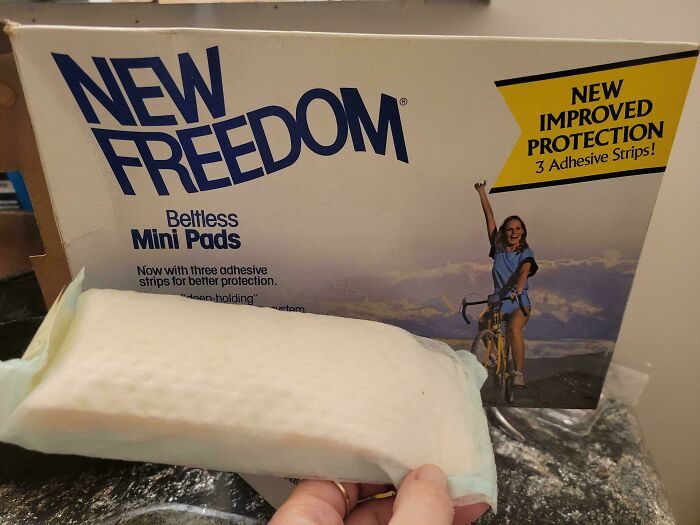 Box of New Freedom beltless mini pads with new improved protection and three adhesive strips, a bizarre old house find.