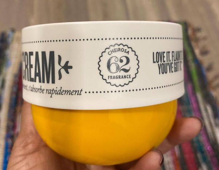 Yellow jar of skin cream with white lid featuring fragrance label, one of the internet gold products found on Amazon trending widely.