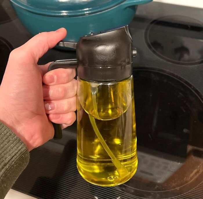 Hand holding a kitchen oil dispenser, one of the popular internet gold products found on Amazon trending everywhere.
