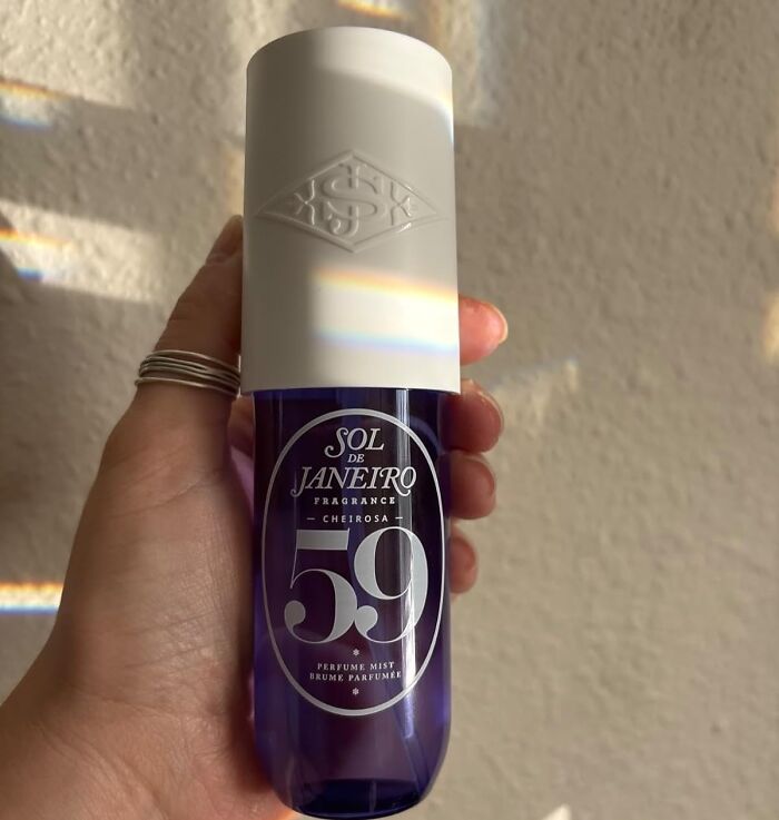 Hand holding Sol de Janeiro 59 perfume mist bottle, one of the internet gold products on Amazon trending everywhere.