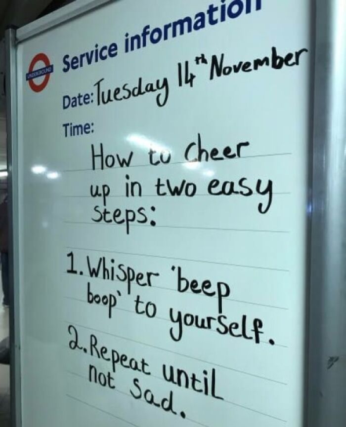 Whiteboard at a transit station with handwritten service information, showing a humorous message, highlighting technology disasters.