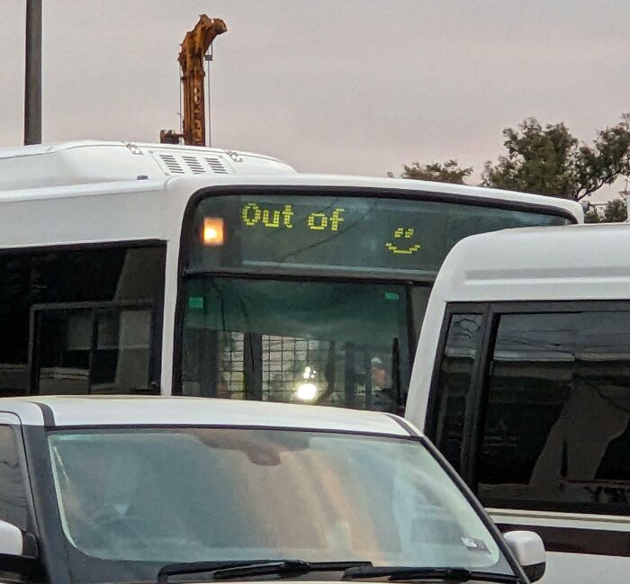 Bus display showing an error message with a smiley face, illustrating a technology disaster in public transportation.