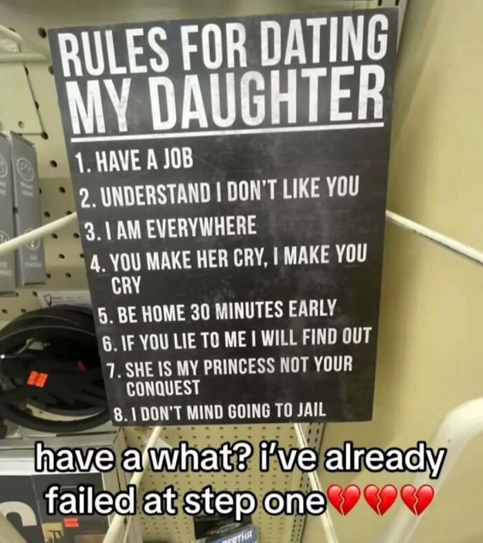 Black sign with cringey dating rules for my daughter, including having a job and other strict demands shown in a store setting.