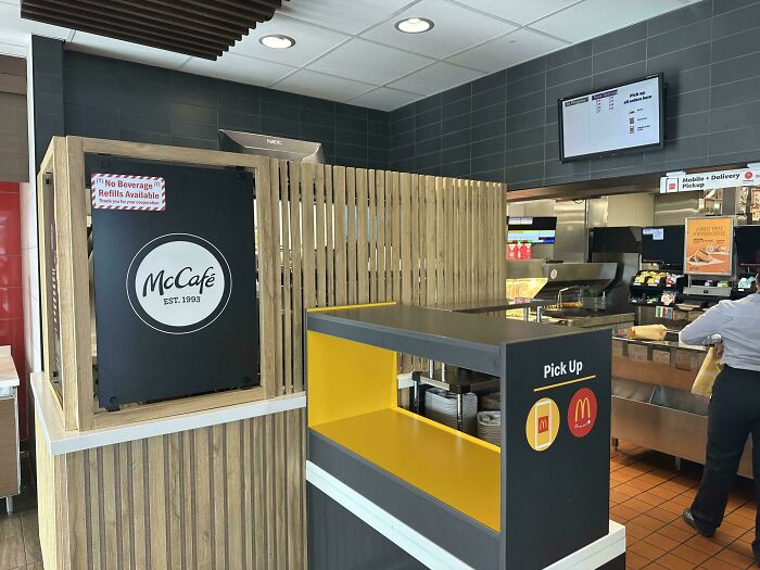 McCafé order pickup area inside a fast-food restaurant illustrating products getting smaller and more expensive.