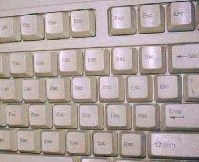 Old computer keyboard with multiple duplicate escape keys creating a visually cursed image for a weird brain break.