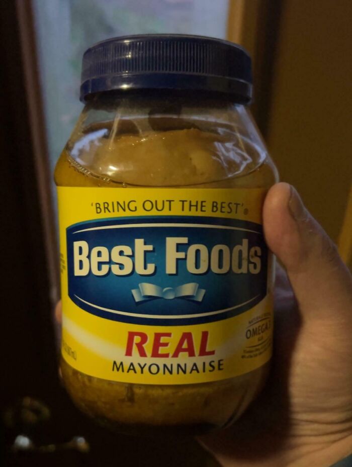 Hand holding a jar of Best Foods mayonnaise found among bizarre things in old houses including first prize string beans.
