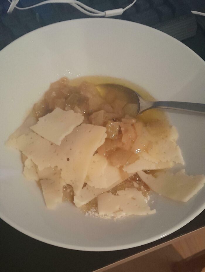 Bowl of cooking fail with broken cheese slices and runny, unappetizing food, highlighting cooking fails and accidents.