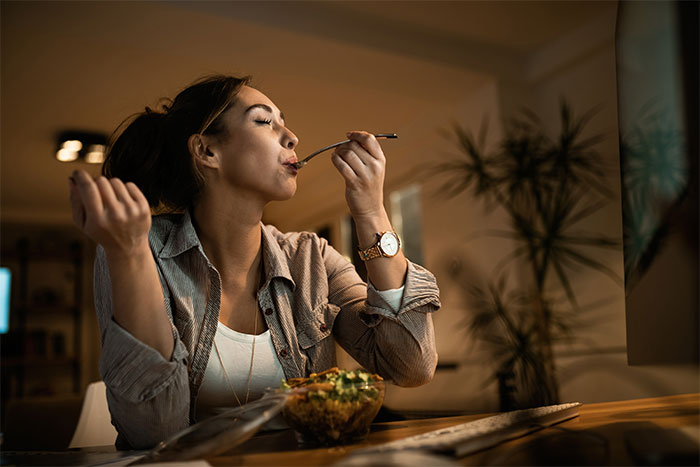 Woman enjoying food alone at home, highlighting person gets revenge on roommate stealing food off plate. Woman enjoying food alone at home, highlighting person gets revenge on roommate stealing food off plate.