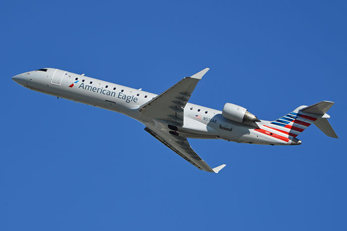 American Eagle regional jet ascending against clear blue sky moments before DC plane crash involving army pilot. American Eagle regional jet ascending against clear blue sky moments before DC plane crash involving army pilot.