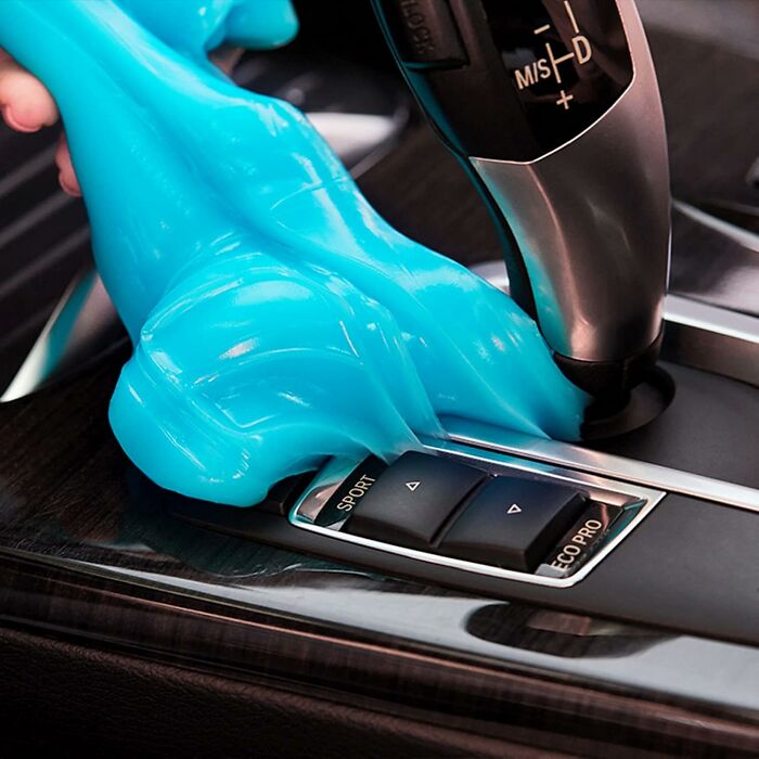 Blue cleaning gel removing dirt from car gear shift panel, showcasing popular internet gold product on Amazon.