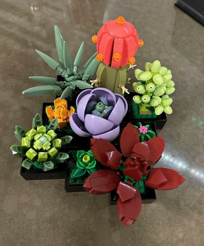 Colorful LEGO succulent plants arranged on a desk as creative office supplies décor to brighten workspace.